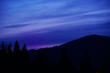 Night in mountains. Silhouette against the sky