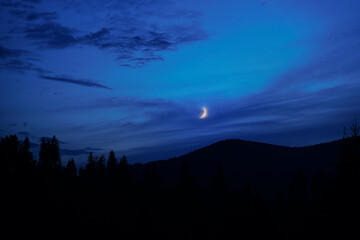 Night in mountains. Silhouette against the sky