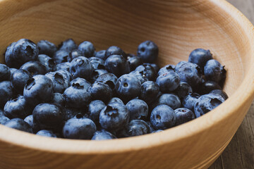 Depevyanaya bowl with ripe large blueberries. Top view composition.