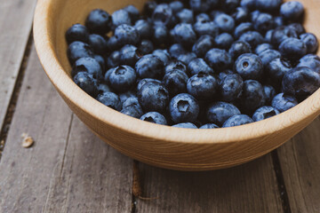 Depevyanaya bowl with ripe large blueberries. Top view composition.