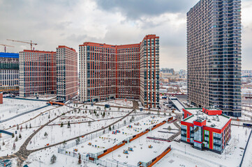 View of the city of Moscow, Moscow City, the capital of Russia from a bird's eye view. Top view in winter with snow. New area, building high. Urban landscape with a courtyard.