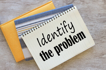 three notepads on the work table. text on the page Identify the problem