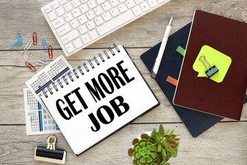 Get More Job, open notepad with text near white keyboard.