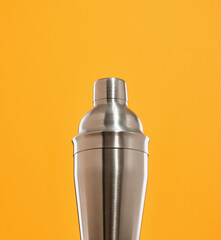 Metal shiny shaker for making delicious, deluxe, gourmet alcoholic drinks and cocktails at the club party. Concept of alcoholic party and celebration.