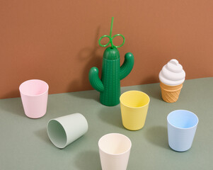 Festive mood. Cocktail party variety. Straw cactus and colorful cups, delicious creamy ice cream.