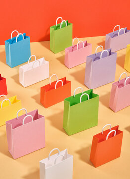 A pattern of colorful shopping bags on a table. Idea of weekend shopping.