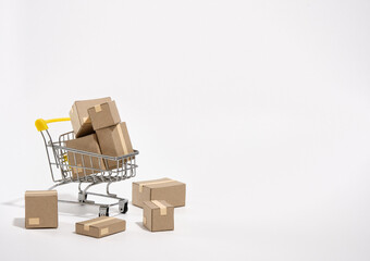 Cardboard boxes in the shopping cart and scattered on the table. Family shopping trip.