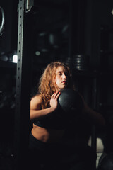 Fototapeta na wymiar Athletic Beautiful Woman squatting with ball at gym. 