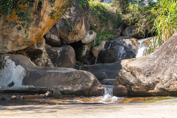 Small mountain waterfall with crystal clear water flowing between rocks. Santa Maria Madalena, Brazil