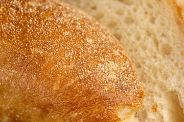 A cut loaf of round-shaped wheat bread