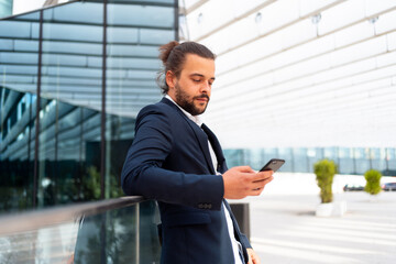 Businessman standing outdoor use smartphone