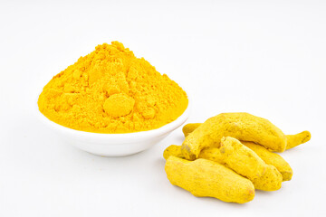 Turmeric powder in bowl on white background, indian spice haladi