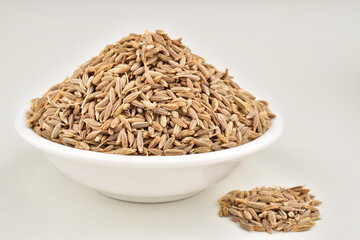 Cumin seeds in bowl isolated on white background