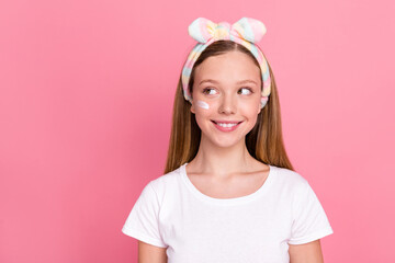 Photo of cute minded positive person beaming smile look empty space peeling cream face isolated on pink color background