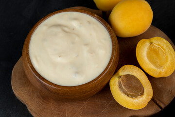 fresh yogurt with taste and chunks of yellow apricot