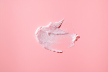 Smear of white face or body cream, lotion, mousse, soap, shower gel on pink background. Cosmetics texture. Spa, skin care, beauty and health, medicine. Cosmetic background, mockup
