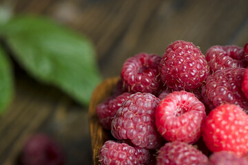 Ripe raspberries on a wooden board