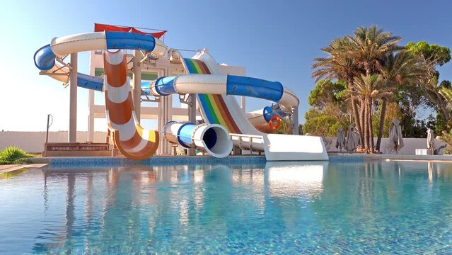 Empty small aquapark sliders with pool and palm trees at the morning, Tunisia