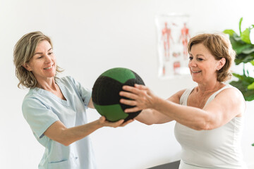 Physiotherapist working with elderly patient in clinic