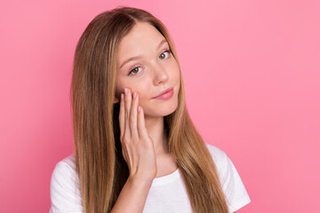 Portrait of positive lovely girl hand fingers touch cheek apply cosmetics empty space isolated on pink color background