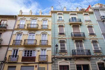 Old colonial buildings at the city of Valencia, Spain, yellow and blue facade