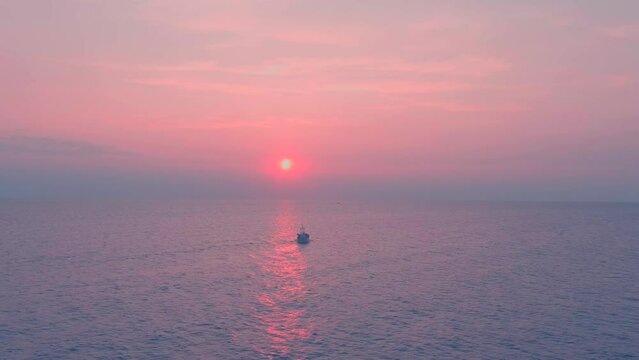 Chalutier en contrejour du soleil levant, trawler on the Mediterranean sea backlight in the rising sun