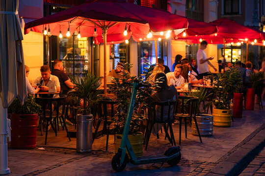  People in Lviv outdoor restaurant. Pravda Beer Theatre