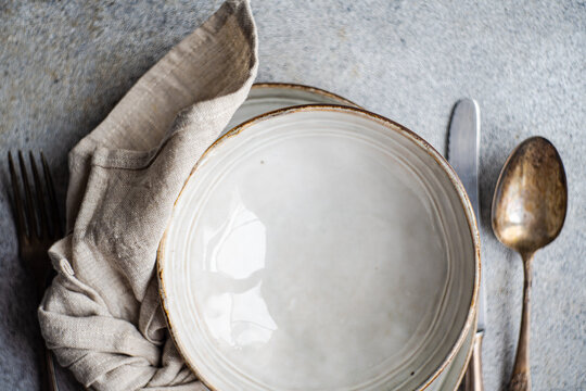 White ceramic bowls with set of fork and spoon
