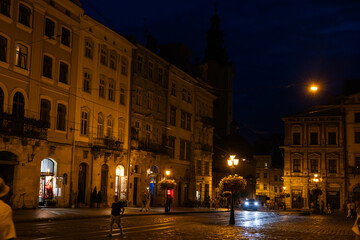 Fototapeta na wymiar People walking on Market Square in Lviv in the evening