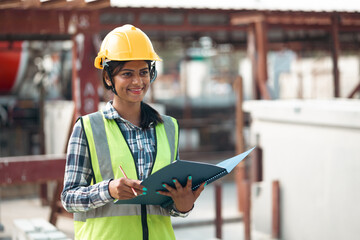 Portrait Asian indian female professional Engineer factory. Engineering worker in safety hardhat at factory industrial facilities. Heavy Industry Manufacturing Factory. Prefabricated concrete walls - obrazy, fototapety, plakaty