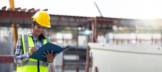 Portrait Asian indian female professional engineer factory. Woman engineering worker in safety hardhat at factory industrial facilities. Heavy Industry. Prefabricated concrete walls