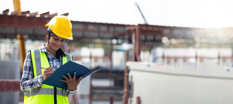 Portrait Asian indian female professional engineer factory. Woman engineering worker in safety hardhat at factory industrial facilities. Heavy Industry. Prefabricated concrete walls