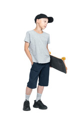 Full-length portrait of a teenager in a T-shirt, shorts and a cap, holding a skateboard in his...