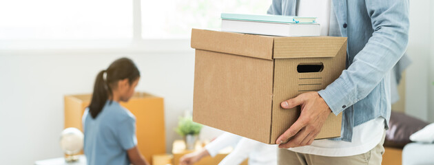 People relocation move home concept, Man carrying belongings box moving in new apartment.