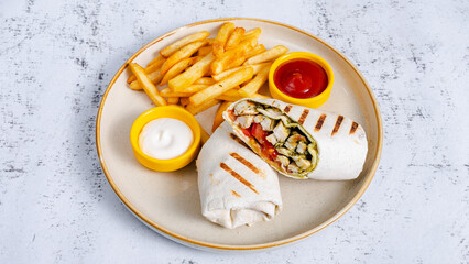 Grilled chicken roll with french fries in plate