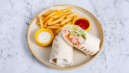 Chicken roll with french fries in plate