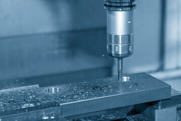 The CNC milling machine cutting press part with ball end mill tool.