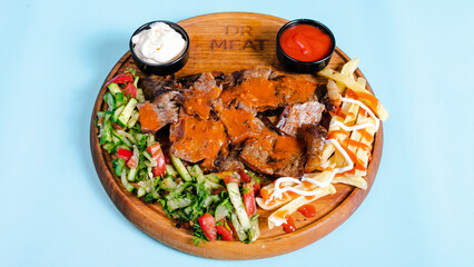 Beef portion doner kebab with fries on tray