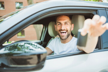 Mid adult man feeling comfortable on driver seat in his new car.