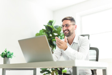 Mature business man using laptop computer in office.