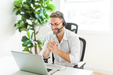 Mature analyst man using laptop computer in office.