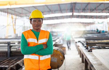 Armcrossed. Portrait Asian professional Engineer factory. Engineering worker in safety hardhat at factory industrial facilities. Heavy Industry Manufacturing Factory. Prefabricated concrete walls