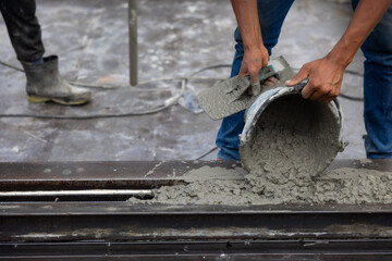 man pouring concrete slab. Asian Engineer man working at precast factory. Engineering worker in...