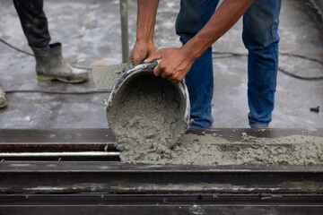 man pouring concrete slab. Asian Engineer man working at precast factory. Engineering worker in safety hardhat at factory industrial facilities. Heavy Industry Manufacturing Factory
