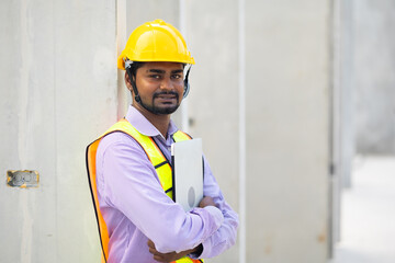 Portrait Asian indian professional Engineer factory. Engineering worker in safety hardhat at factory industrial facilities. Heavy Industry Manufacturing Factory. Prefabricated concrete walls