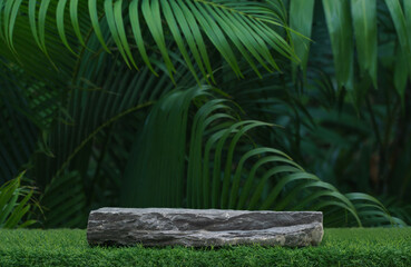 Stone tabletop counter podium floor in outdoors tropical garden forest blurred green palm leaf plant nature background.Natural product placement pedestal stand display,summer jungle paradise concept.