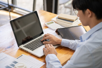 Man working by using a laptop computer Hands typing on keyboard. writing a blog. Working at home are in hand finger typewriter.