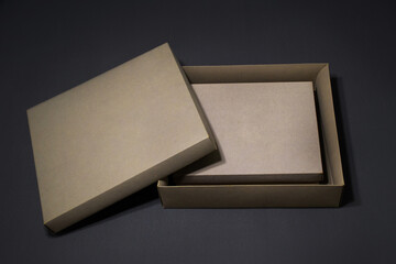 Box packaging in craft color on gray background
