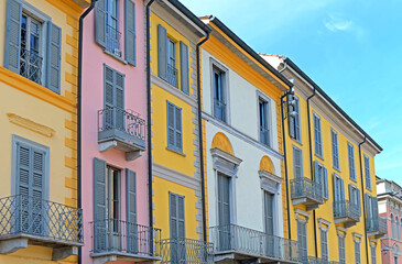 Obraz premium Typical ancient colorful houses with wrought iron balcony in the centre of Lodi, Lombardy, Italy on a bright spring day