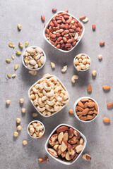 Healthy mix nuts on wooden background. Almonds, hazelnuts, cashews, peanuts, pistachios, Brazilian nuts